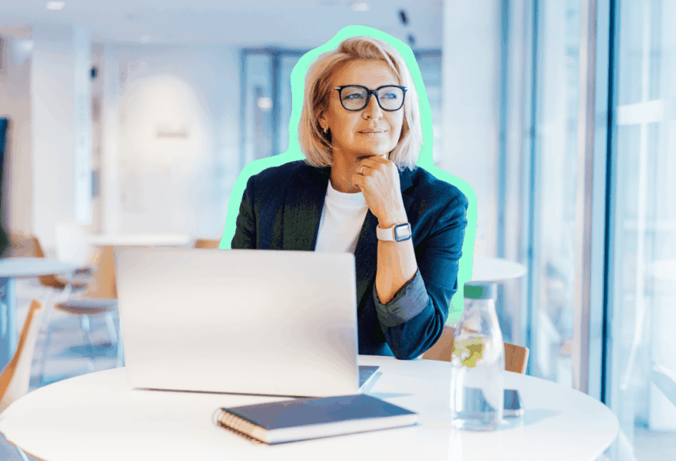 Blonde business woman looking off to the side while on a laptop