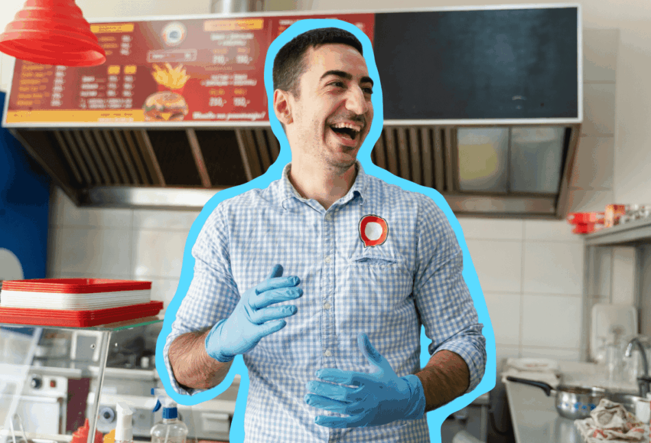 Man in a button-up shirt with gloves on standing in a fast food restaurant