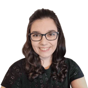 Headshot of smiling woman with black-framed glasses and brunette hair.