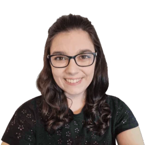 Headshot of smiling woman with black-framed glasses and brunette hair.