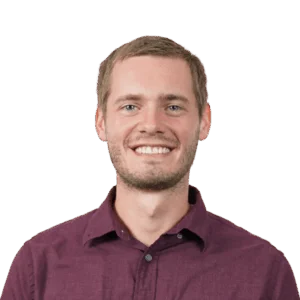 Portrait of a smiling man in burgundy shirt, transparent background.