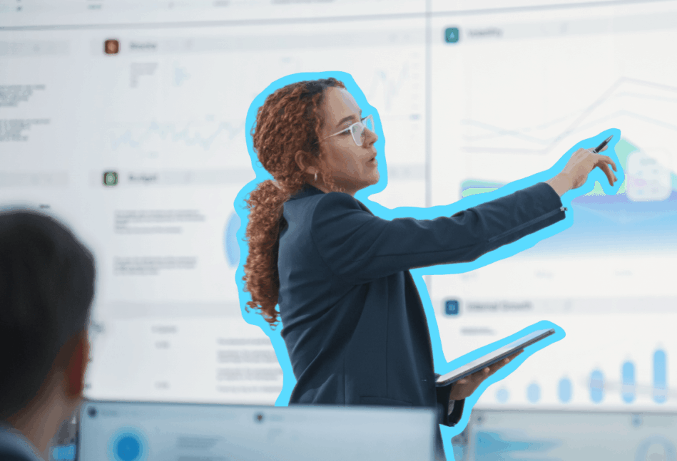A woman in finance pointing at information on a board