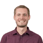 Portrait of a smiling man in burgundy shirt, transparent background.
