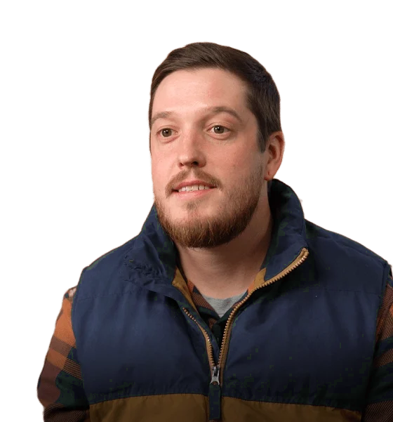 a man with a beard is wearing a blue vest