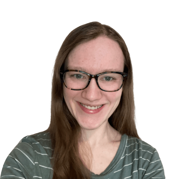 Smiling woman with glasses and long hair against a white background