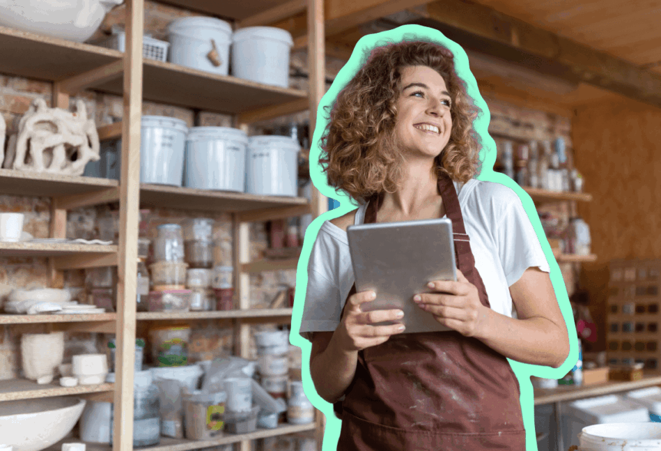 Small business owner standing and smiling in her shop